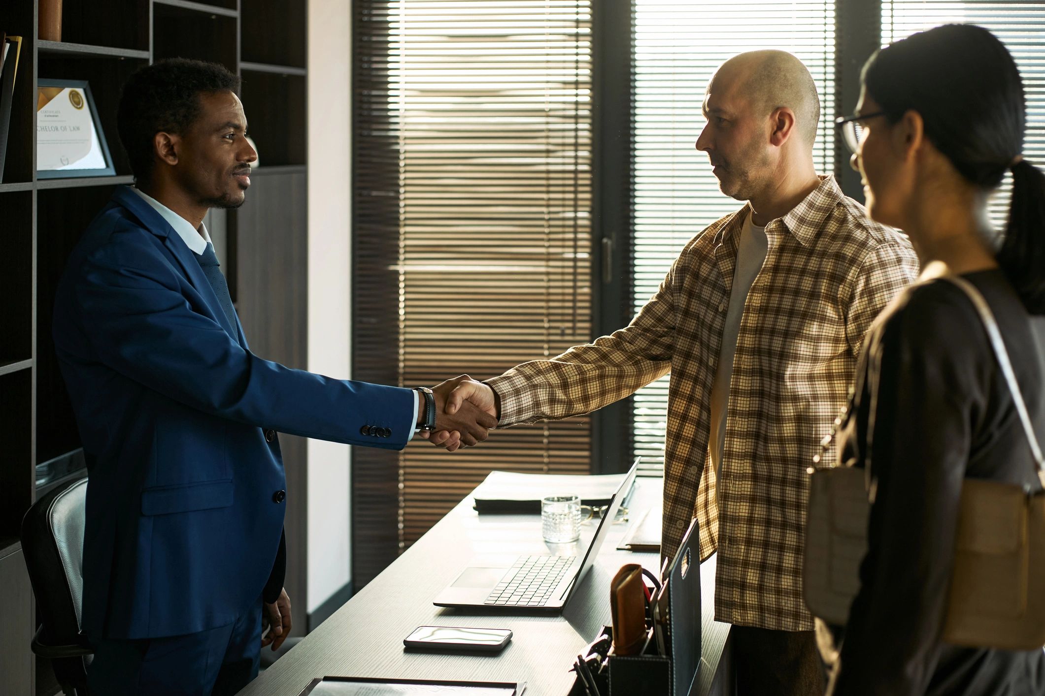 Advisor greeting clients during a professional meeting